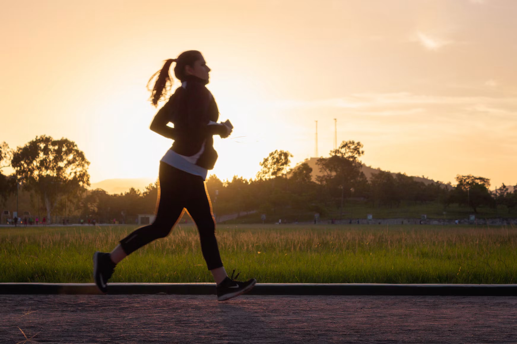 Woman running in golden-hour light, photographed by McCarthy Beckan on Unsplash
