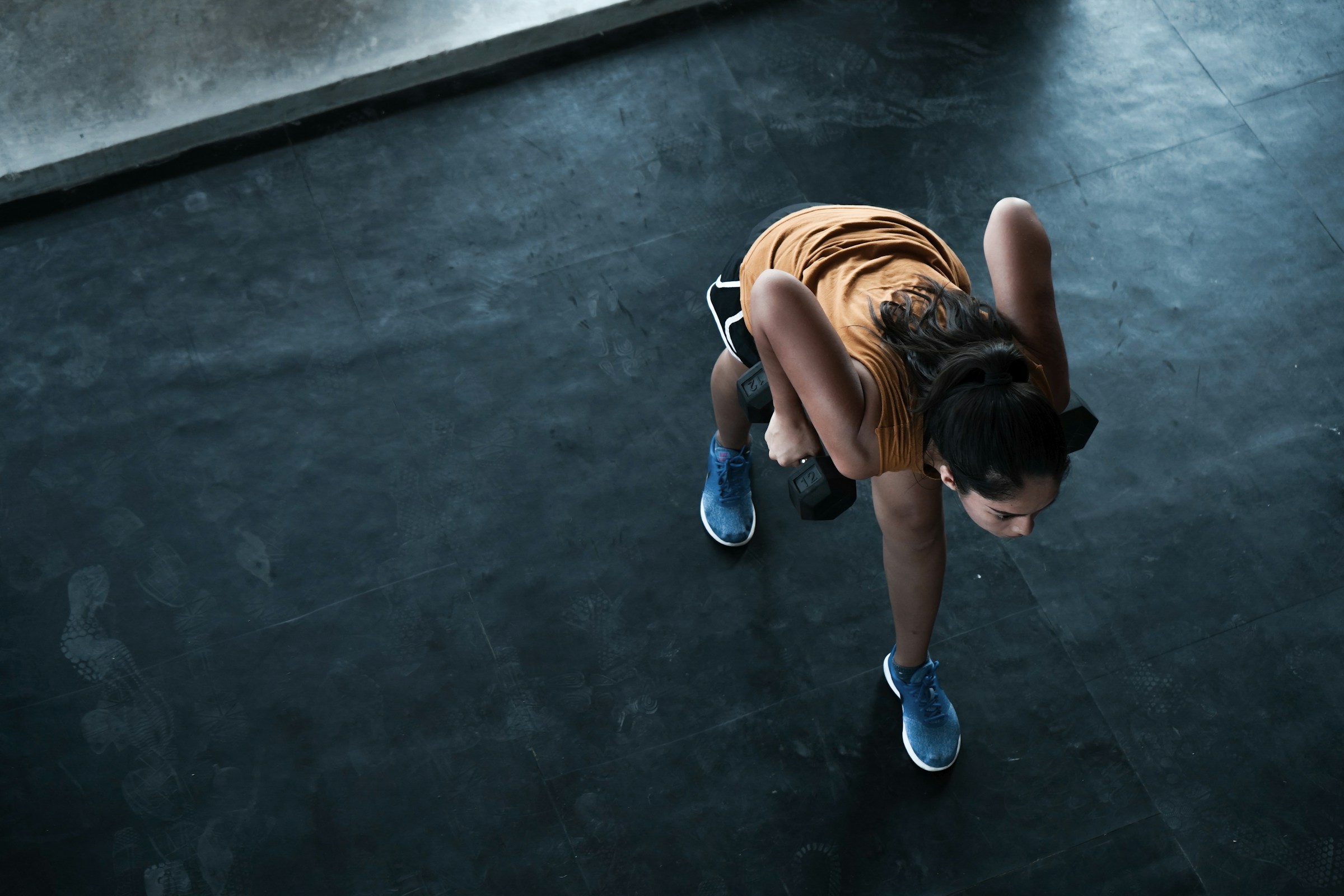 Woman exercising indoors, photographed by Eduardo Cano Photo Co. on Unsplash